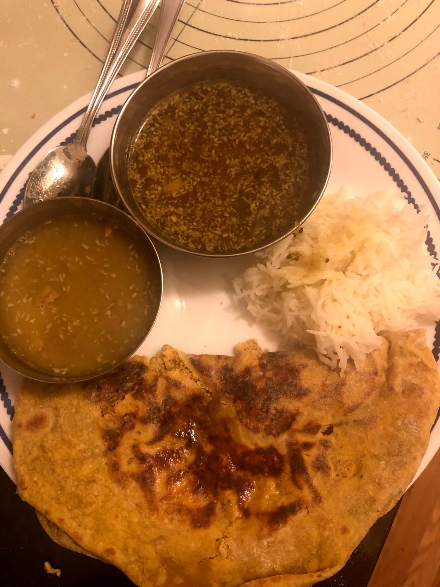 Katachi Aamti next to the rice, hanging out with friends—Ambat Goad Varan and Puran Poli!